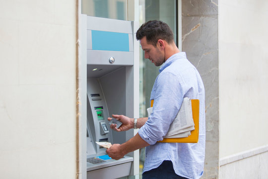 Man withdrawing cash from cash machine