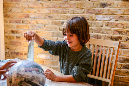 Child playing with papier mache