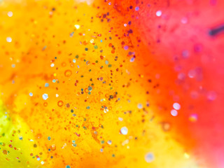 Abstract vivid red, orange, yellow and glitter plastic texture