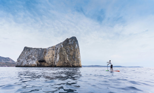 Man paddleboarding, Pan di zucchero, Sardinia, Italy