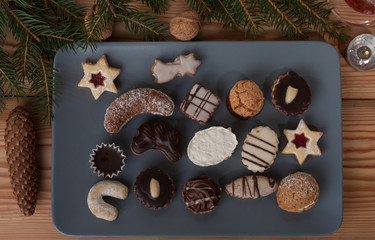 Christmas cookies on a plate, a table decorated with spruce twig