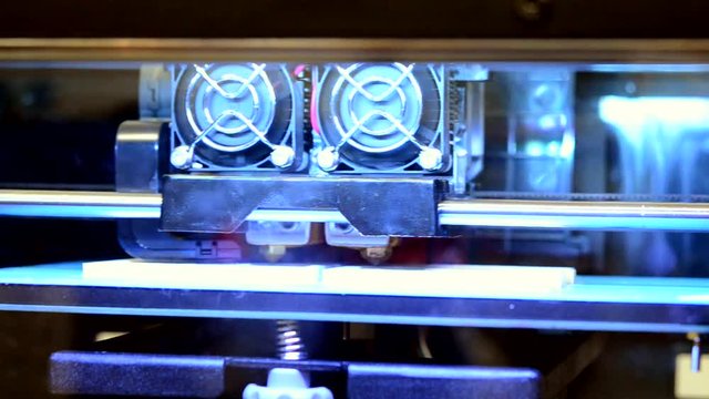 3D printer printing two flat part at the same time close-up