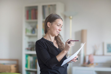 Mature woman reading document