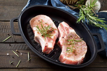 Raw meat. Raw pork on the bone in cast iron grill frying pan wit