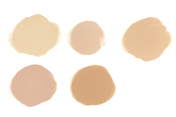Set of five face make-up liquid foundation samples on a white background