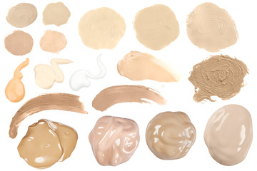Many different face make-up liquid and creme foundation samples on a white background