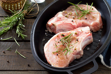 Raw meat. Raw pork on the bone in cast iron grill frying pan wit