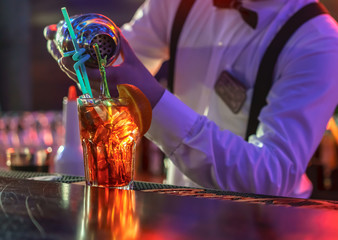 Bartender is making cocktail at bar counter