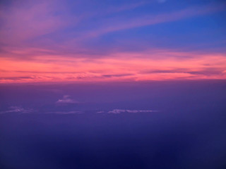 ariel view of clouds and sky in sunset above city