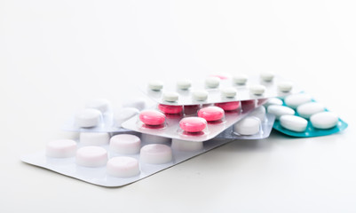 Stack of pills on white background