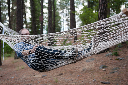 Man relaxing in hammock, Spokane, Washington, USA