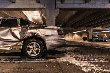 Damaged car in underground parking lot