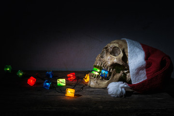 Still life skull wear santa claus hat with gift blinker light.
