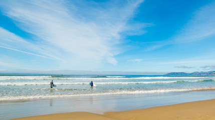 Fototapeta na wymiar Surfers in Pismo Beach