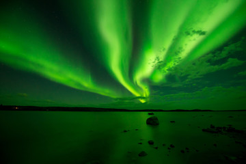 Northern Lights Over A Lake - Waves of aurora borealis passing over a lake. Yellowknife, NWT, Canada.