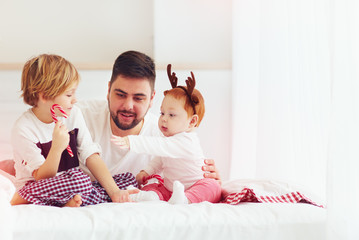 happy father and kids having fun in christmas morning at home