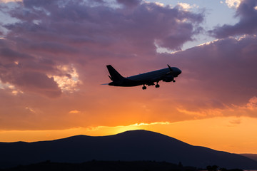 Fototapeta na wymiar Passenger airplane flying in the sky at sunset