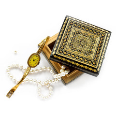 carved wooden box with gold jewelry