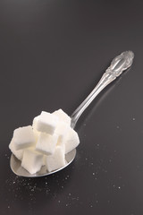 Fototapeta na wymiar giant spoon with cube sugar