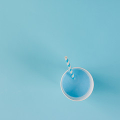 Blue drink with straw. Flat lay minimal concept.