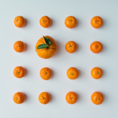 Creative pattern made of tangerines and orange on bright backgro