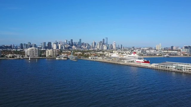 Orbit shot of pier in Port Melbourne and view of skyline in CBD