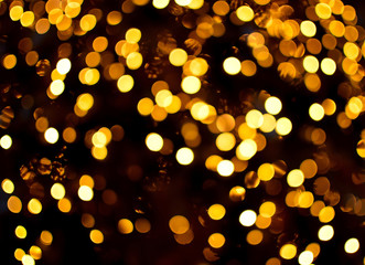 Gold bokeh light. Christmas background. Xmas tree blur lights for greeting card.
