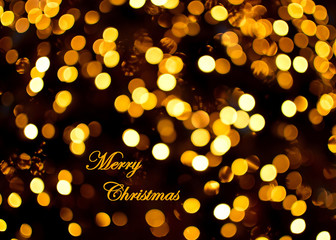Gold bokeh light. Christmas background. Xmas tree blur lights for greeting card.