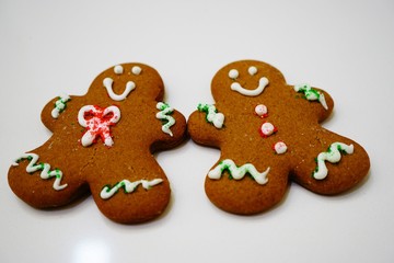Two gingerbread men cookies decorated for Christmas