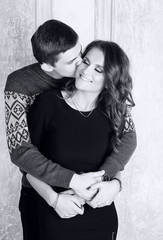 Young man kisses his beautiful girlfriend. Black and white