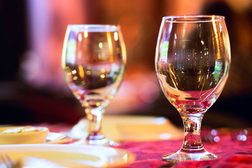 two wine glasses on red tablecloth