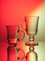 Two colorless transparent glass in red and yellow backlight through a matte screen.