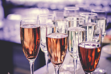 photo of champagner glasses on glass table with bokeh background