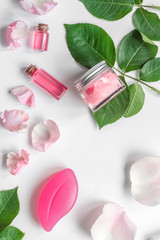 organic cosmetic with rose oil on white background top view