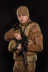 Fototapeta premium Portrait soldier or private military contractor holding rifle.