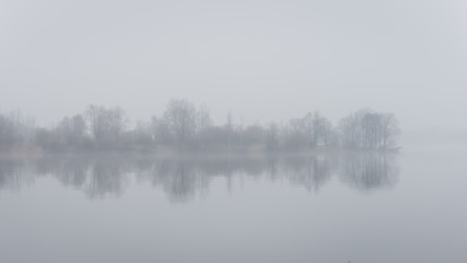 heavy mist over the river in autumn