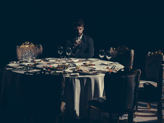 Handsome man drinks wine