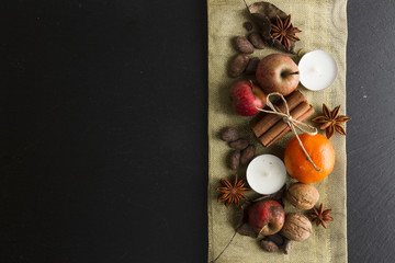 Rustic Christmas decoration with cinnamon apple anise tangerine candle...