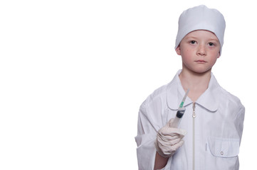 Boy was a doctor in a medical gown, cap, with syringe in hand on