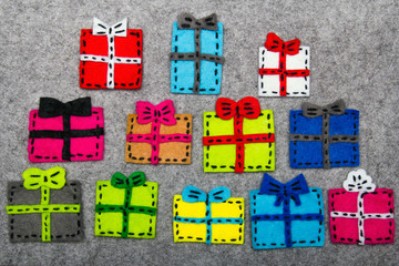 Obraz premium Christmas gifts on grey background. Felt Christmas ornaments with copy space