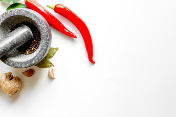 spices and stone mortar white background top view mock up
