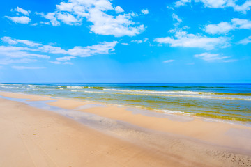 Fototapeta na wymiar Sea waves on white sand Debki beach, Baltic Sea, Poland