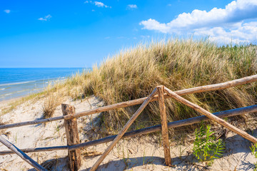 Wooden fence on sand dune on coast of Baltic Sea near Lubiatowo beach, Poland