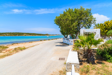 Naklejka premium Coastal road along a beach near Naoussa village, Paros island, Greece