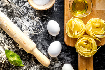 cooking process of pasta on dark background top view