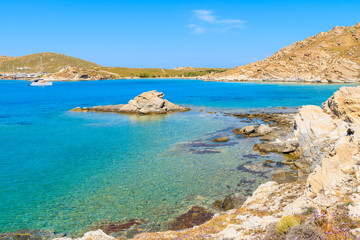 Fototapeta na wymiar Beautiful coast with crystal clear sea water in Monastiri bay on Paros island, Greece