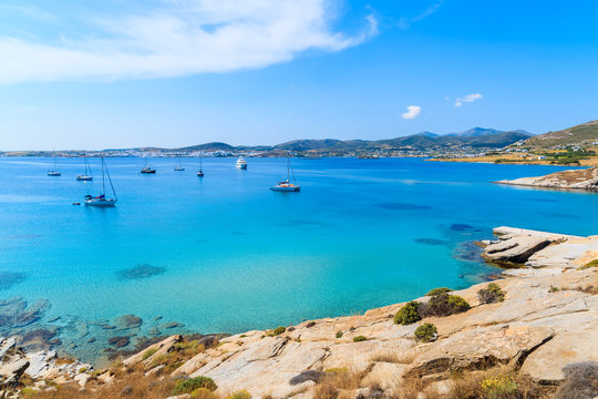 Sailing boats on azure sea in Monastiri bay on Paros island, Greece