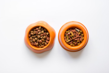 dry pet food in bowl on white background top view
