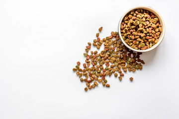 dry cat food in bowl on white background top view