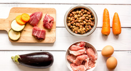 ingredients for pet food holistic top view on wooden background